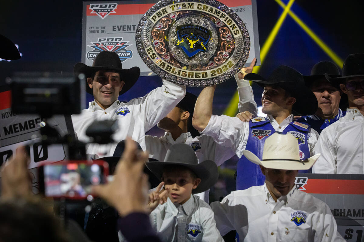 The Nashville Stampede team members hold up their championship prize at the Pro Bull Riders tea ...