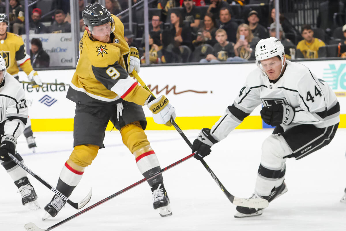 Golden Knights center Jack Eichel (9) shoots under pressure from Los Angeles Kings defenseman M ...