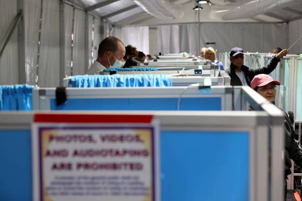 Voters cast their ballots in an event tent at Arroyo Market Square on the last day of early vot ...