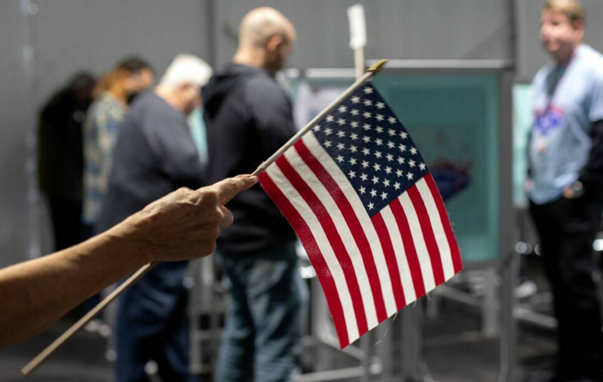 An election volunteer directs voters on the last day of early voting, Friday, Nov. 4, 2022, at ...