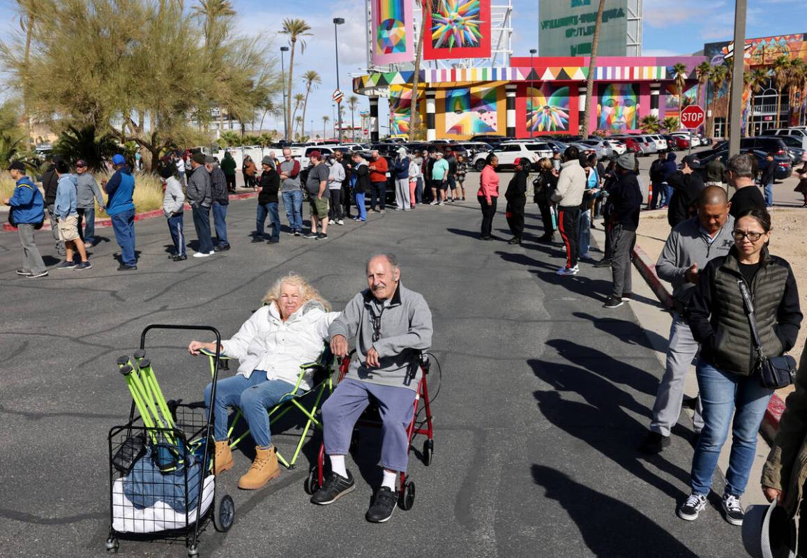 People, including Kathryn Newman and her uncle Zeev Amzalem of Las Vegas, wait in line to buy l ...