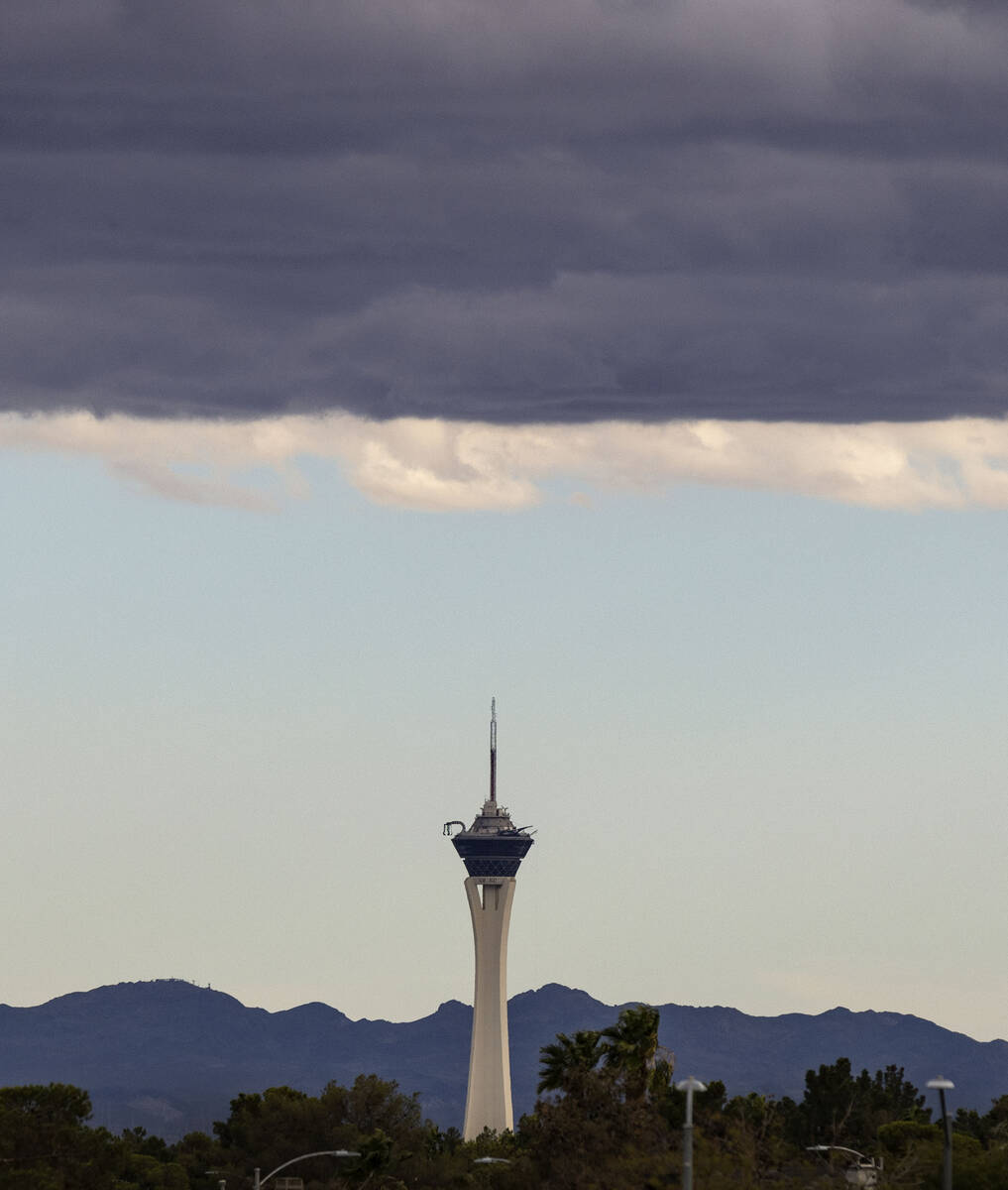 The Stratosphere is seen as clouds linger over the Las Vegas valley during a cool and windy aft ...