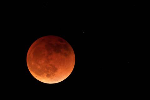 The moon is shown during a full lunar eclipse, Sunday, May 15, 2022, near Moscow, Idaho, with t ...
