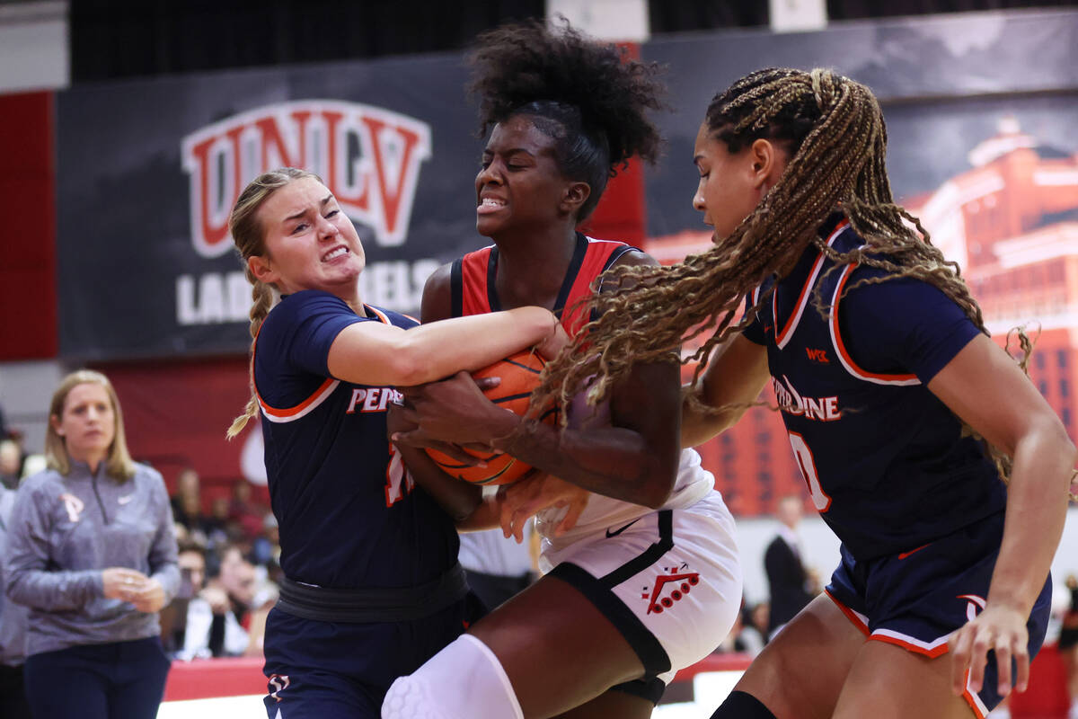 UNLV's Desi-Rae Young (23) and Pepperdine's Marly Walls (12) fight for the ball during the firs ...