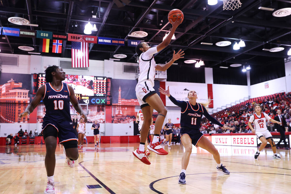 Pepperdine's Jane Nwaba (10) and Helena Friend (11) look on as UNLV's Justice Ethridge (11) tak ...