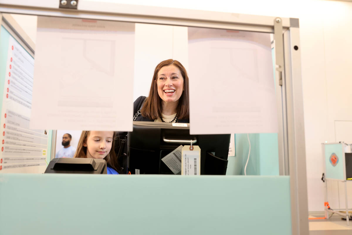 Lt. Gov. Lisa Cano Burkhead votes with her daughter Raquel, 10, at East Las Vegas Library durin ...