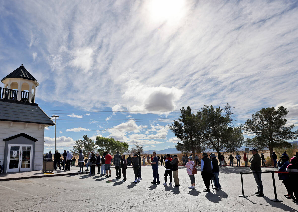 People wait in line to buy lottery tickets at the Lotto Store just across the Nevada/California ...