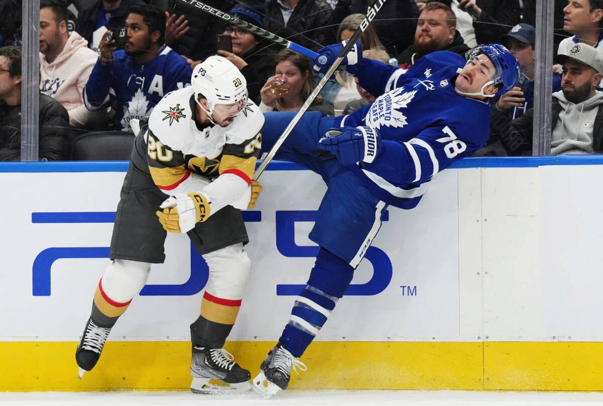 Vegas Golden Knights forward Chandler Stephenson (20) checks Toronto Maple Leafs defenseman TJ ...