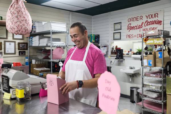 Juan Medina assists customers at his shop, Mrs. Williams’ Diabetic Delights, where the b ...
