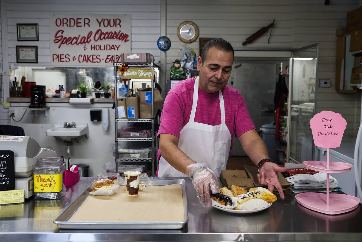 Juan Medina sets out pastries at his shop, Mrs. Williams’ Diabetic Delights, in Las Vega ...