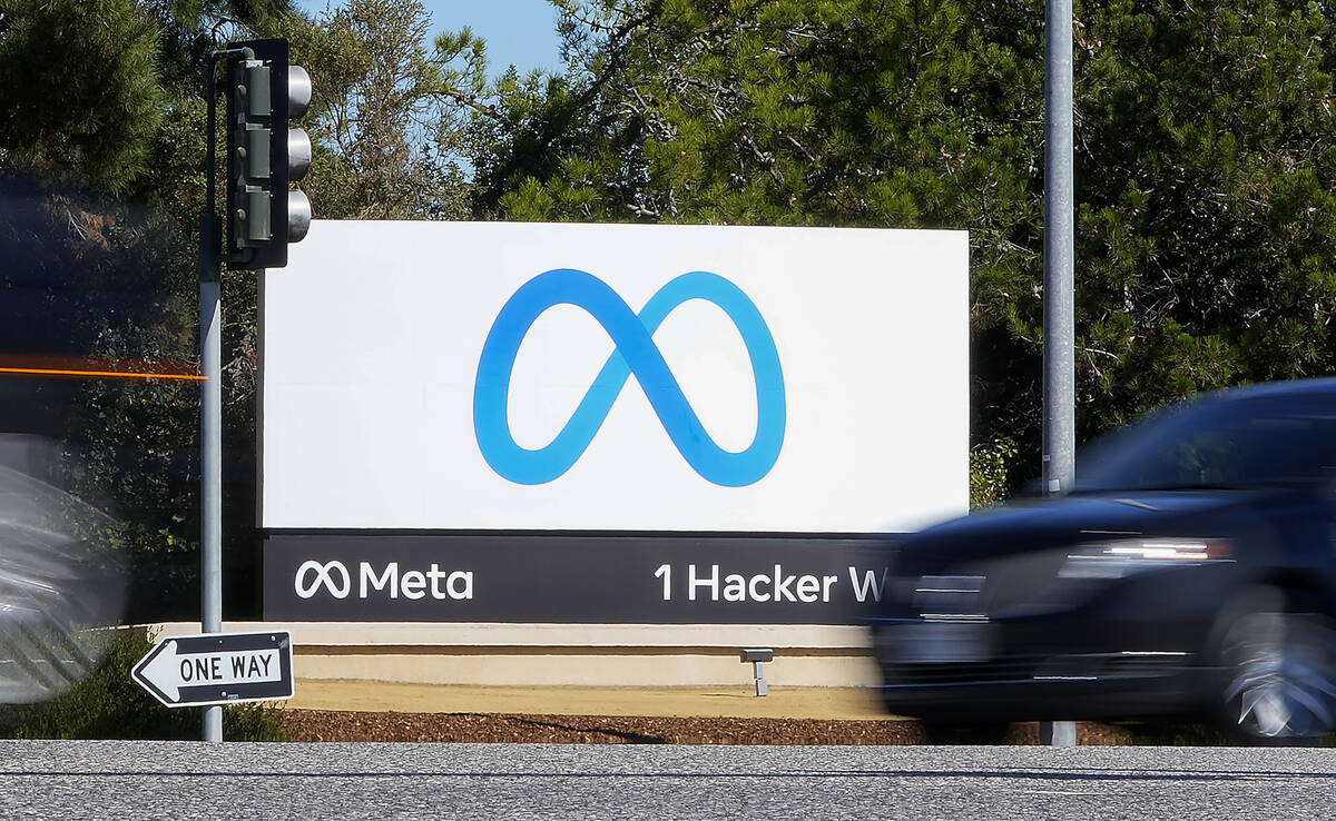 FILE - A car passes Facebook's new Meta logo on a sign at the company headquarters on Oct. 28, ...