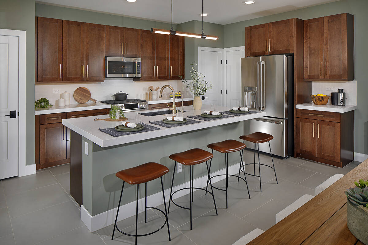 This home by Tri Point Homes in Arroyo's Edge is an example of a kitchen with a center island t ...