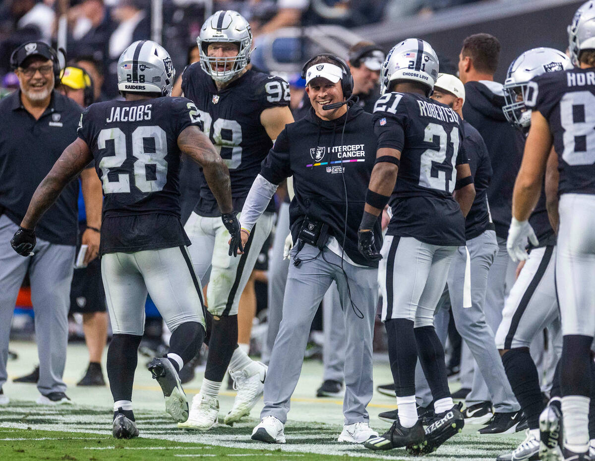 Raiders running back Josh Jacobs (28) runs off after a third touchdown to the delight of Head C ...