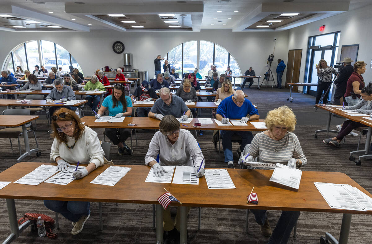 Volunteers resume hand counting ballots in Nye County at the Valley Conference Center on Thursd ...