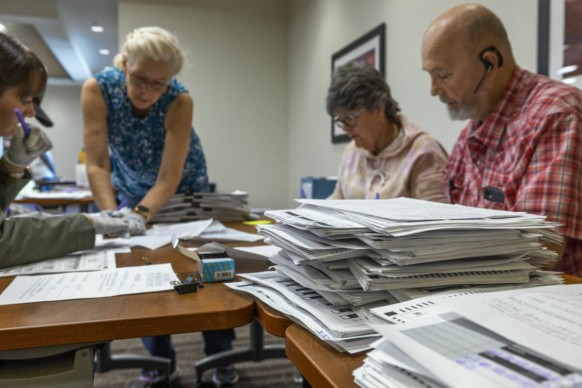 Volunteers resume hand counting ballots in Nye County at the Valley Conference Center on Thursd ...