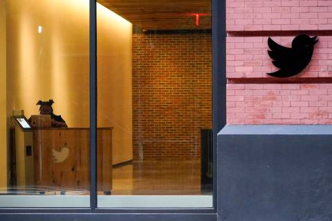 FILE - A receptionist works in the lobby of the building that houses the Twitter office in New ...