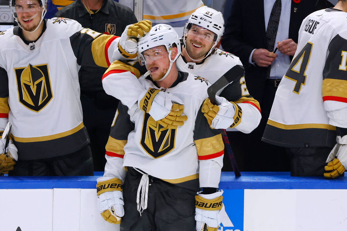 Vegas Golden Knights center Jack Eichel (9) and center Brett Howden (21) celebrate the team's 7 ...