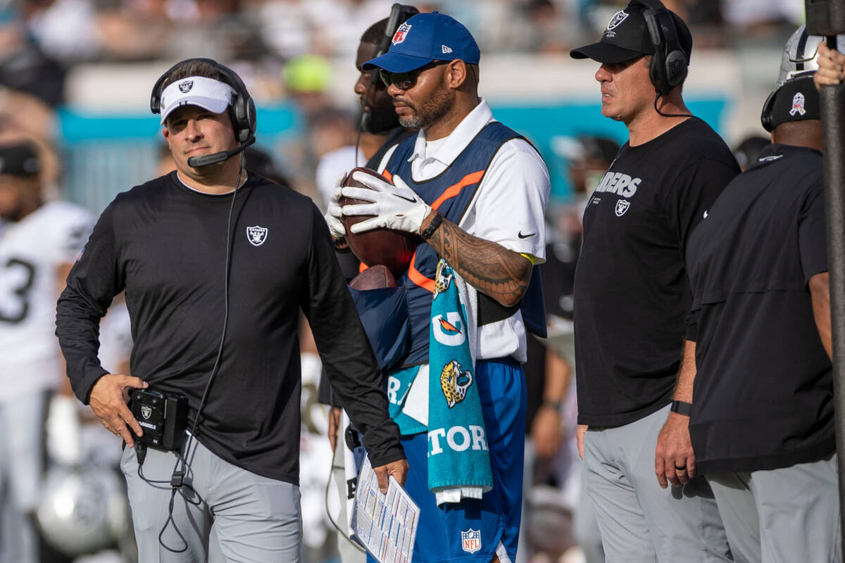 Raiders head coach Josh McDaniels looks to the scoreboard during the second half of an NFL game ...