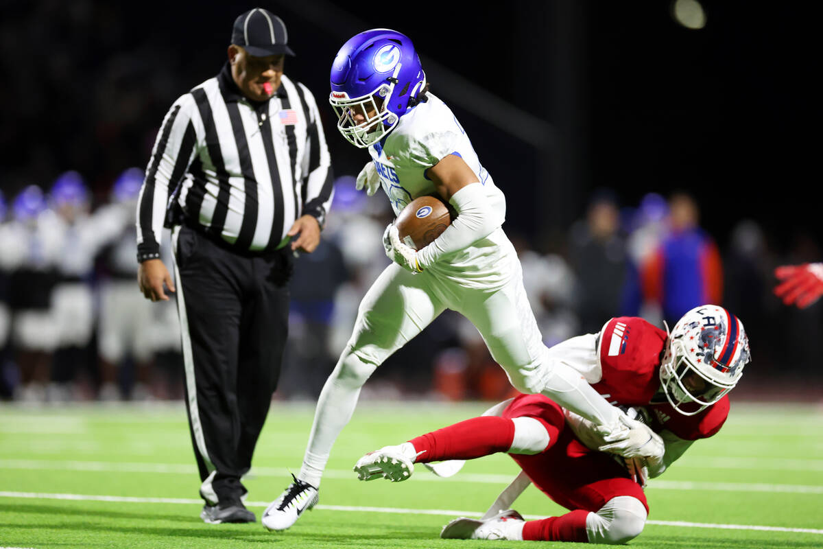 Bishop Gorman's Micah Kaapana (22) avoids a tackle by Liberty's Ashtin Kekahuna-Lopes (9) duri ...