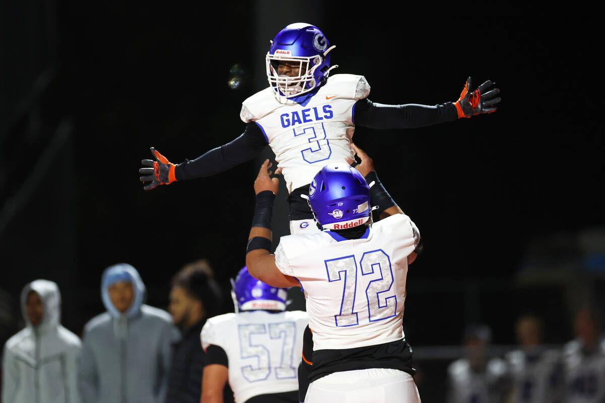 Bishop Gorman's Devon Rice (3) celebrates his touchdown with Douglas Utu (72) during the first ...