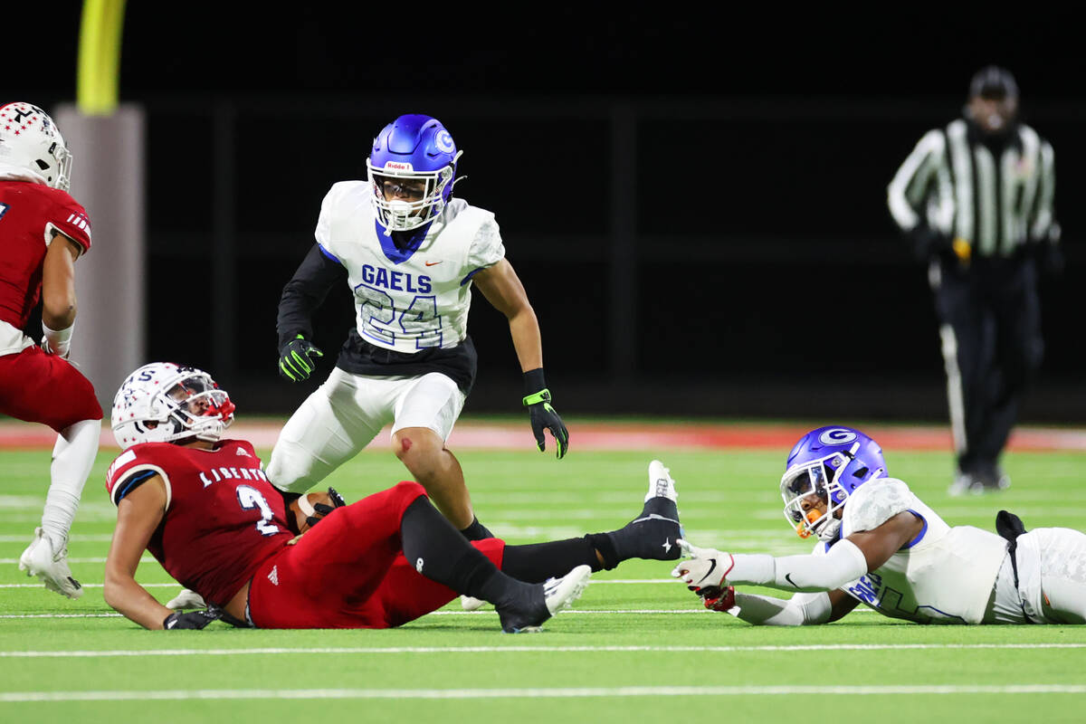 Bishop Gorman's Jeremiah Vessel (5) tackles Liberty's Andre Porter (2) during the second half o ...