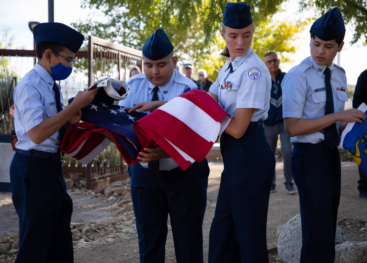 Members of Rancho High school Airfare Junior ROTC fold flags during a ceremony in honor of the ...