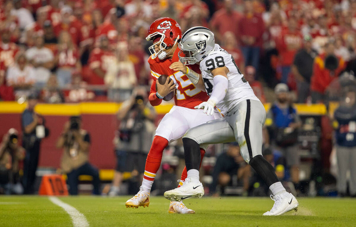 Raiders defensive end Maxx Crosby (98) sacks Kansas City Chiefs quarterback Patrick Mahomes (15 ...