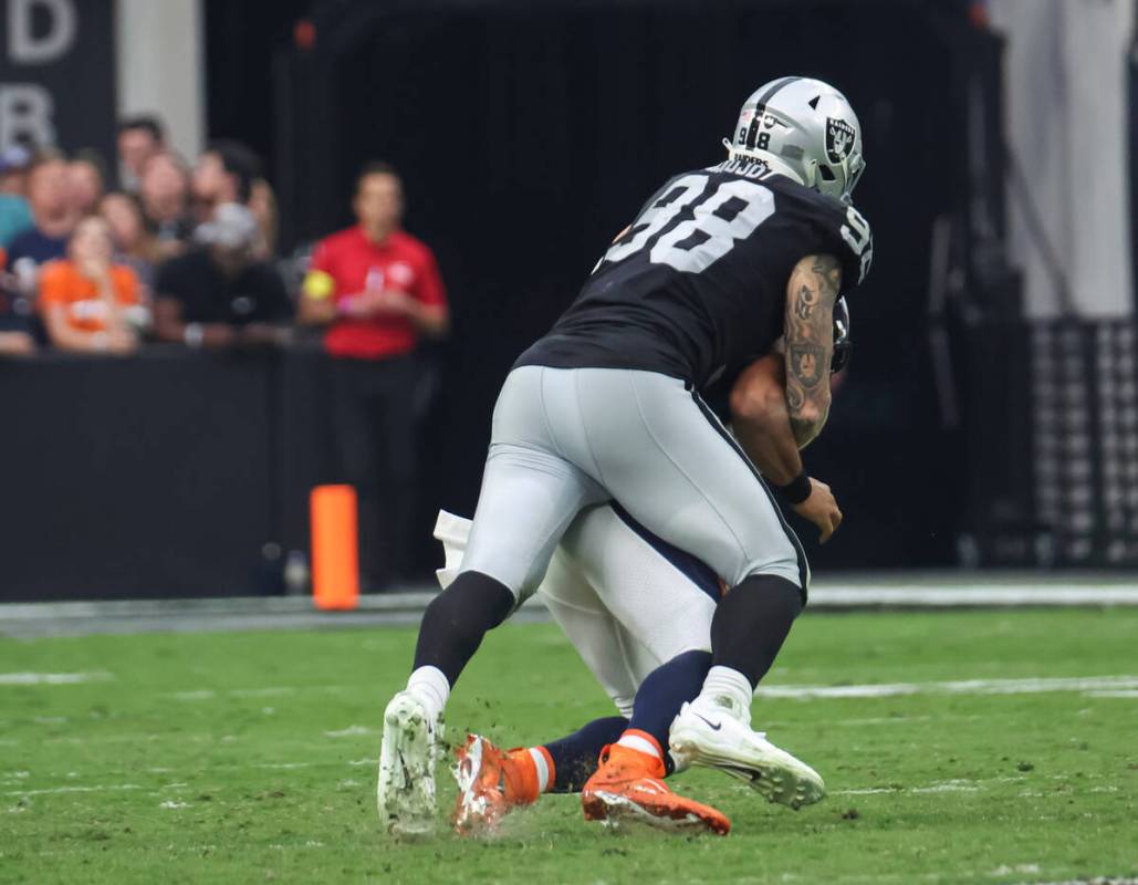 Raiders defensive end Maxx Crosby (98) sacks Denver Broncos quarterback Russell Wilson (3) duri ...