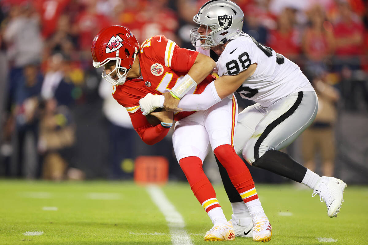 Raiders defensive end Maxx Crosby (98) sacks Kansas City Chiefs quarterback Patrick Mahomes (15 ...