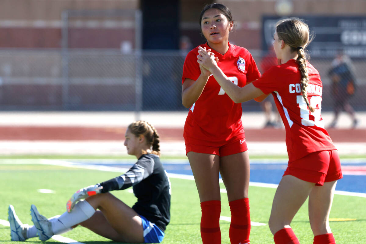 McQueen's High goalie Leah Nisenfeld sits dejected on the floor as Coronado High's Asia Moises ...