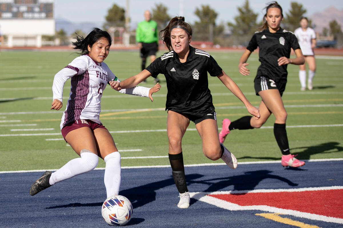 Faith Lutheran’s Mia Coe dribbles against Galena’s Emory Elgin, center, during a ...