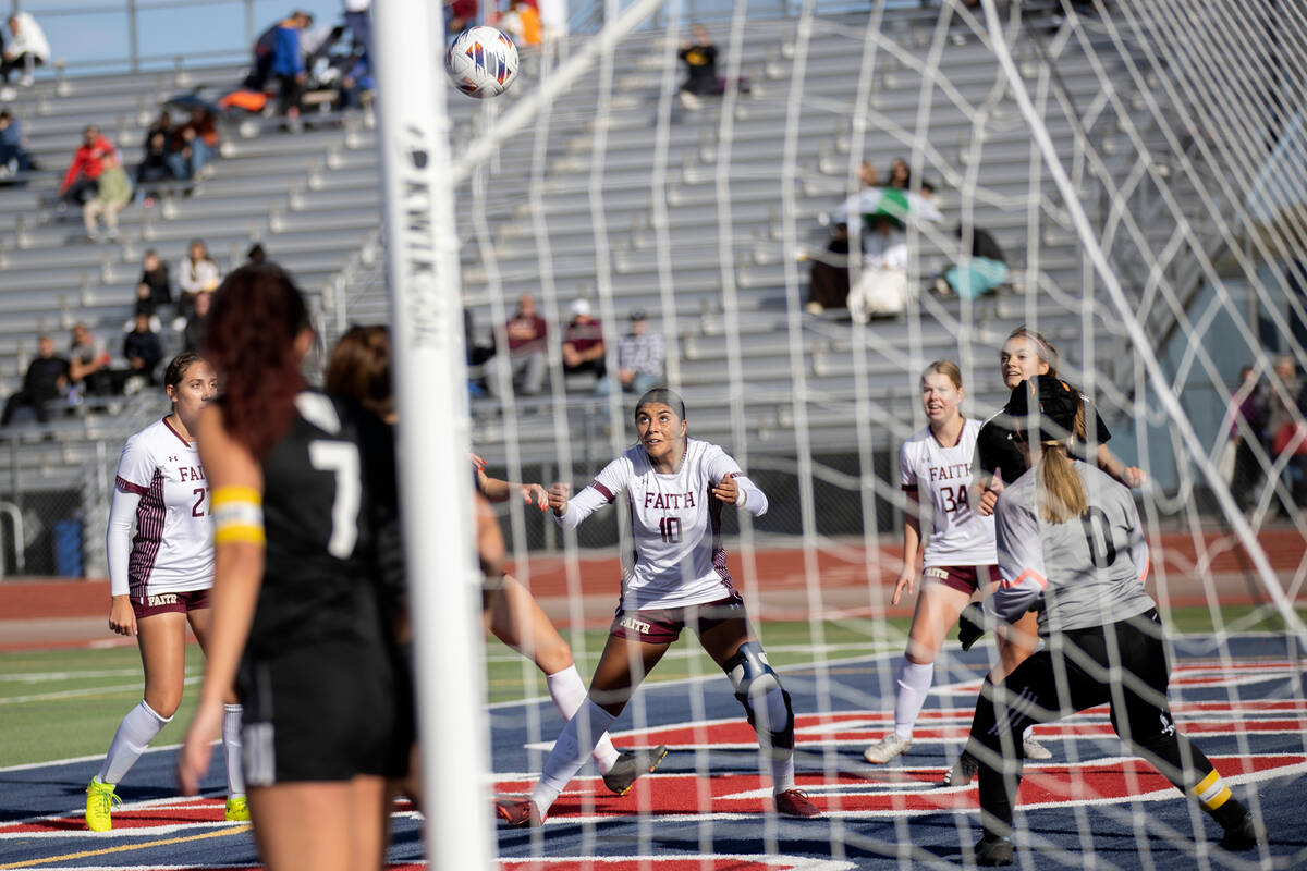 Faith Lutheran’s Andrea Leyva (10), center, anticipates a header before scoring during a ...