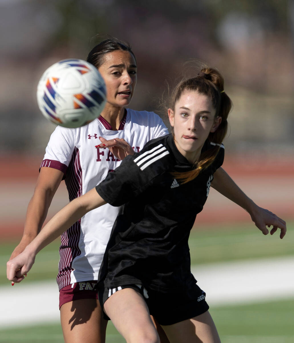 Galena’s Kennedy Hartley, right, eyes her pass while colliding with Faith Lutheran&#x201 ...