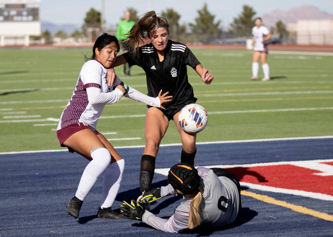 Galena’s Elizabeth Mehrtens (0) saves a shot on goal by Faith Lutheran’s Mia Coe, ...