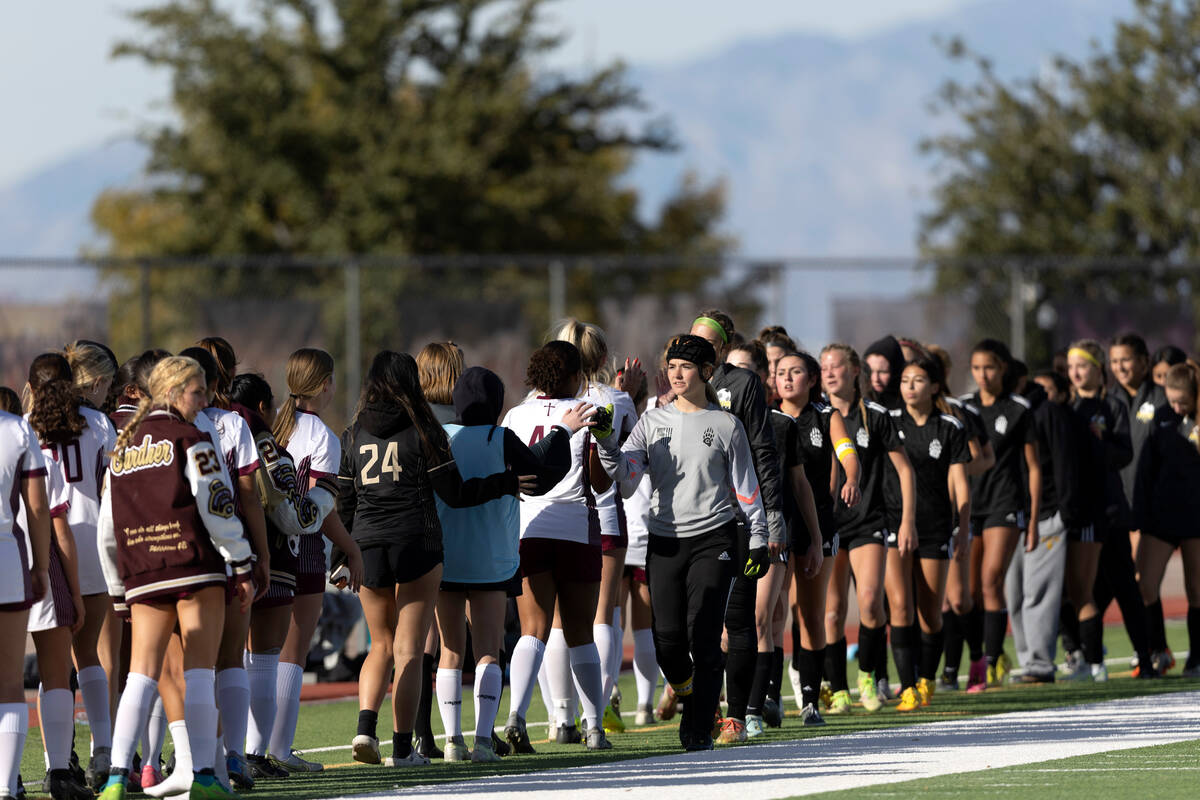 Faith Lutheran and Galena slap hands after Faith won a Class 5A girls high school soccer state ...