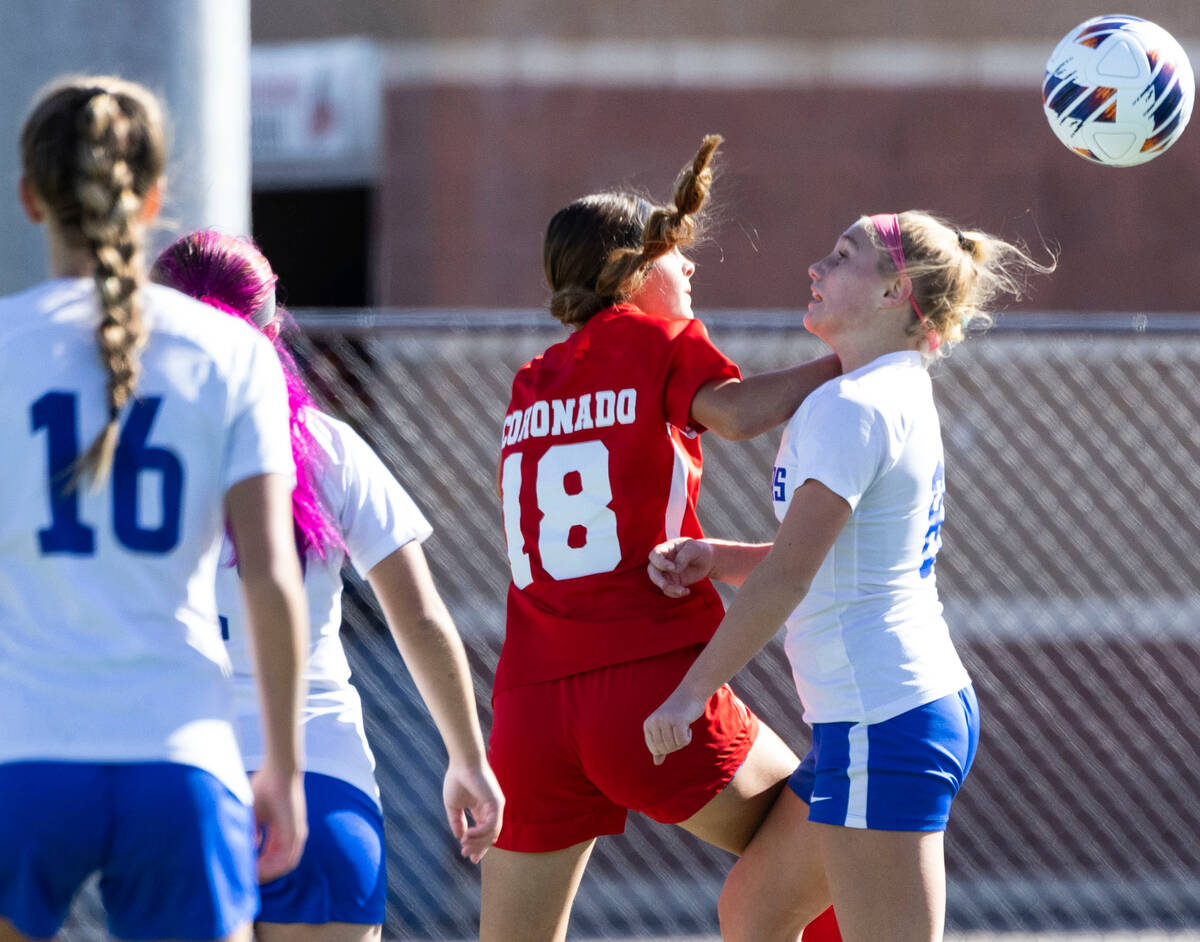 Coronado High's Trinity Buchanan (18) and McQueen's High Ella Barber (8) jump for the ball duri ...