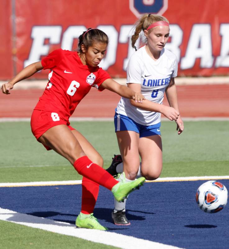 Coronado High's Milan Cordone (6) crosses the ball as McQueen's High Ella Barber (8) defends du ...