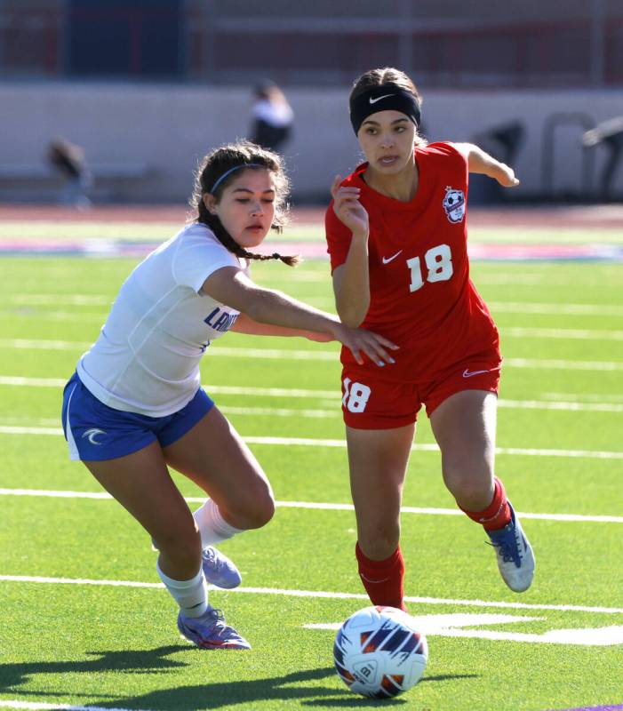 Coronado High's Trinity Buchanan (18) drives past McQueen's High Allysa Allan (4) during the se ...