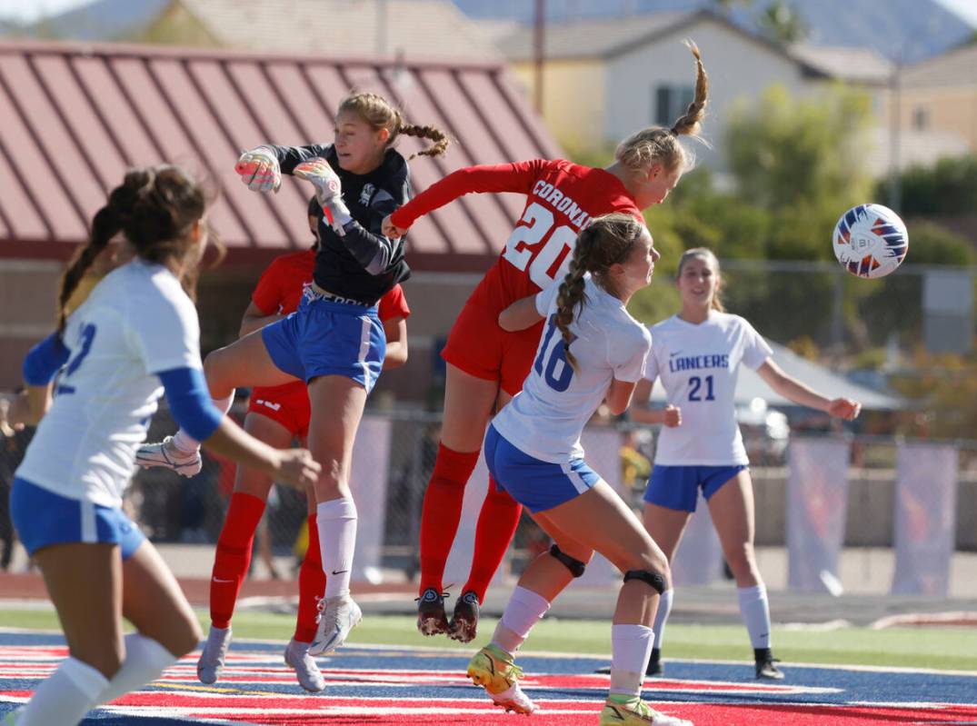 McQueen's High goalie Leah Nisenfeld deflects a corner kick from Coronado High's Cate Gusick (2 ...