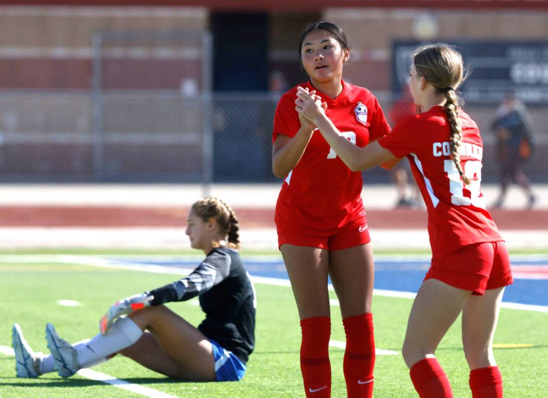 McQueen's High goalie Leah Nisenfeld sits dejected on the floor as Coronado High's Asia Moises ...