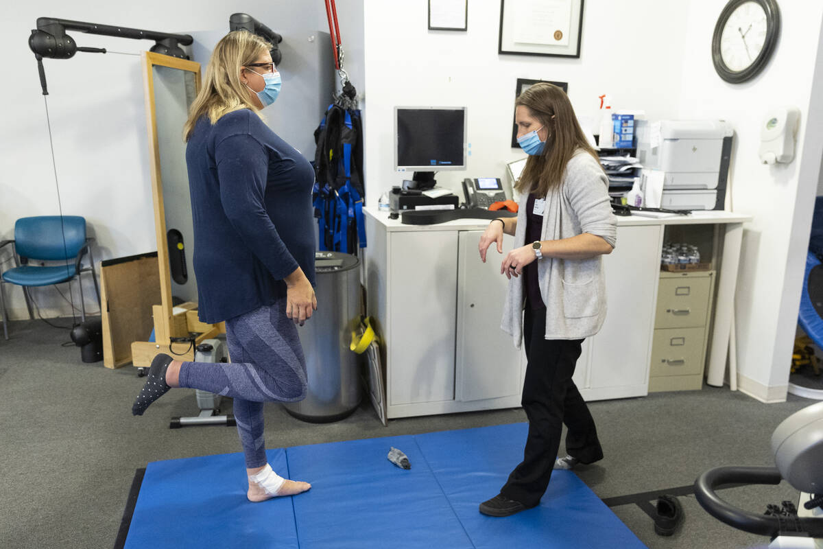 Gwen Vaughn, left, diagnosed with Parkinson's disease, works with her physical therapist Kelly ...