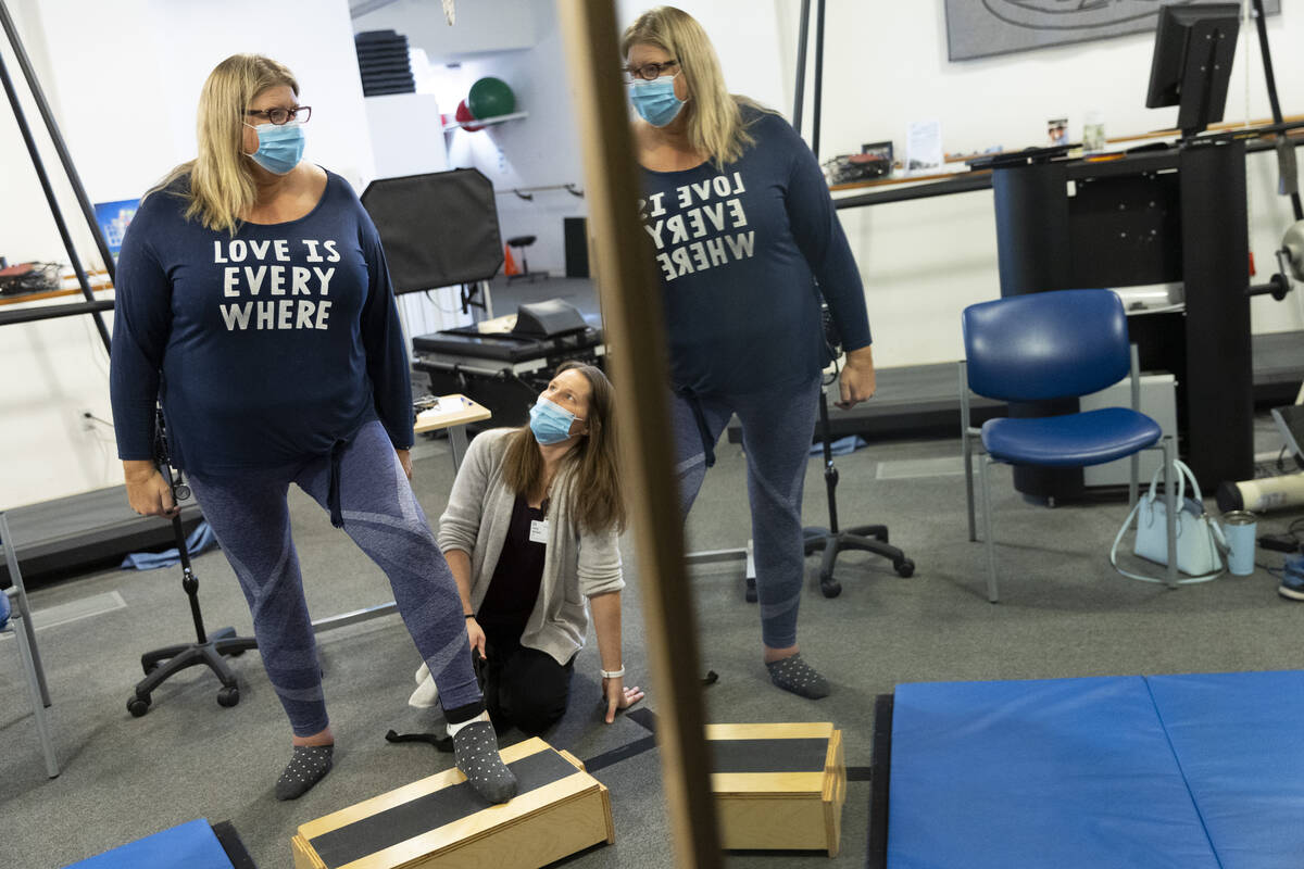 Gwen Vaughn, left, diagnosed with Parkinson's disease, works with her physical therapist Kelly ...