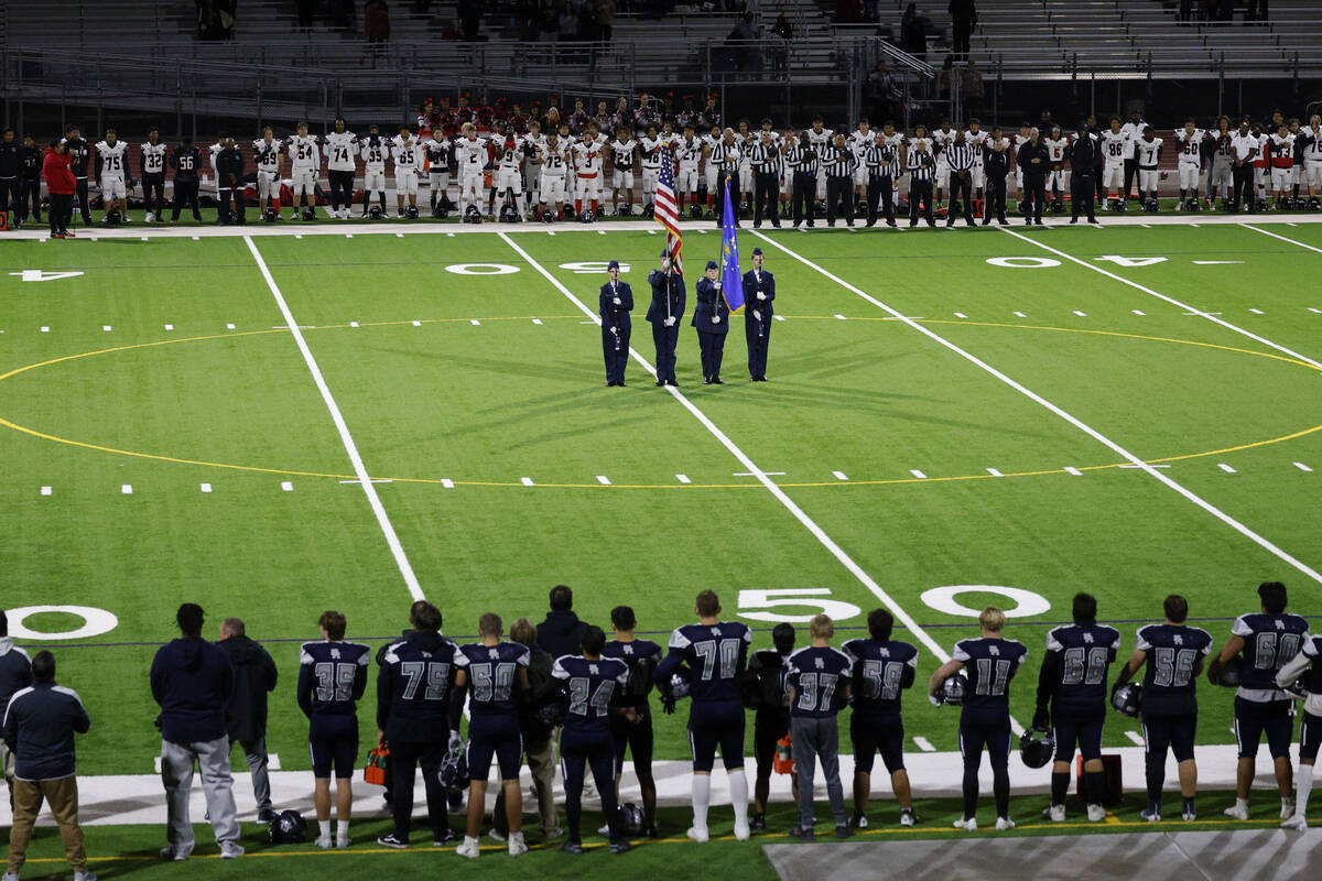 Shadow Ridge High School players, foreground and Las Vegas High School players line up for the ...