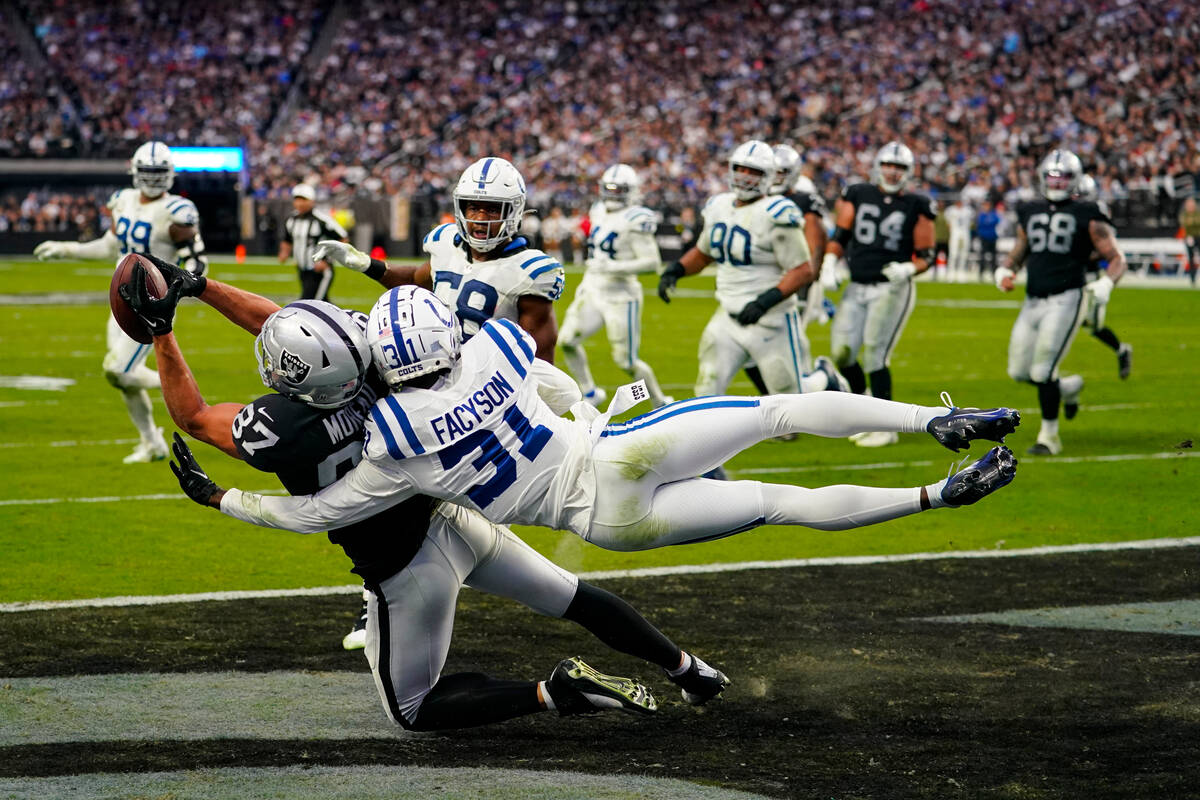 Las Vegas Raiders tight end Foster Moreau (87) makes a catch for a touchdown as he's hit by Ind ...