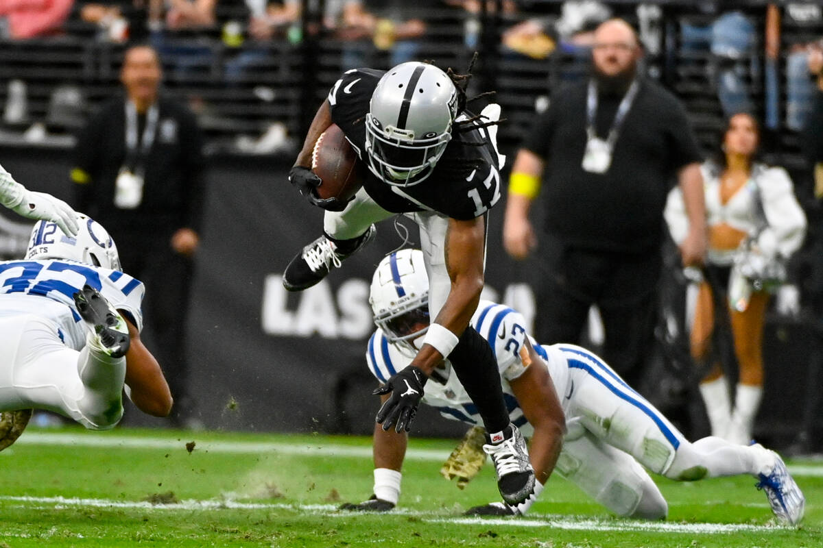 Las Vegas Raiders wide receiver Davante Adams (17) dives for yardage as he runs against the Ind ...