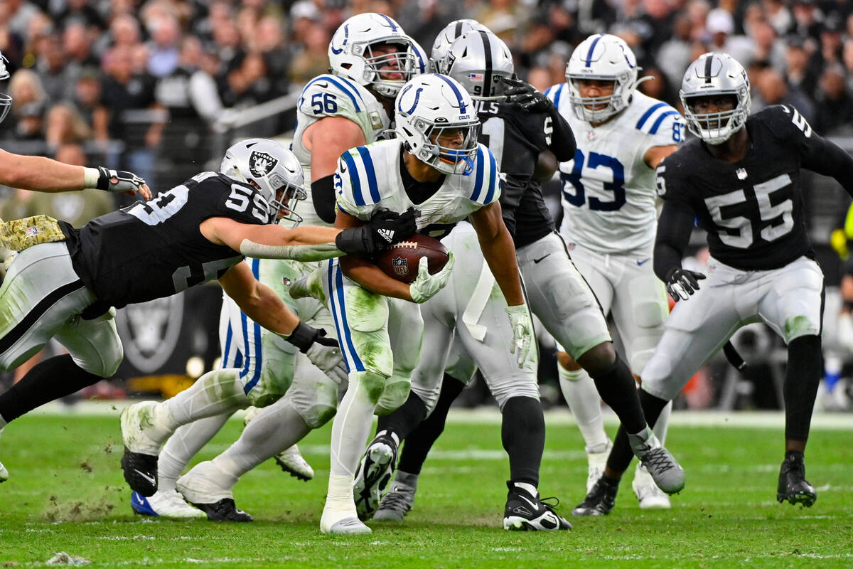 Indianapolis Colts running back Jonathan Taylor (28) is tackled by Las Vegas Raiders linebacker ...