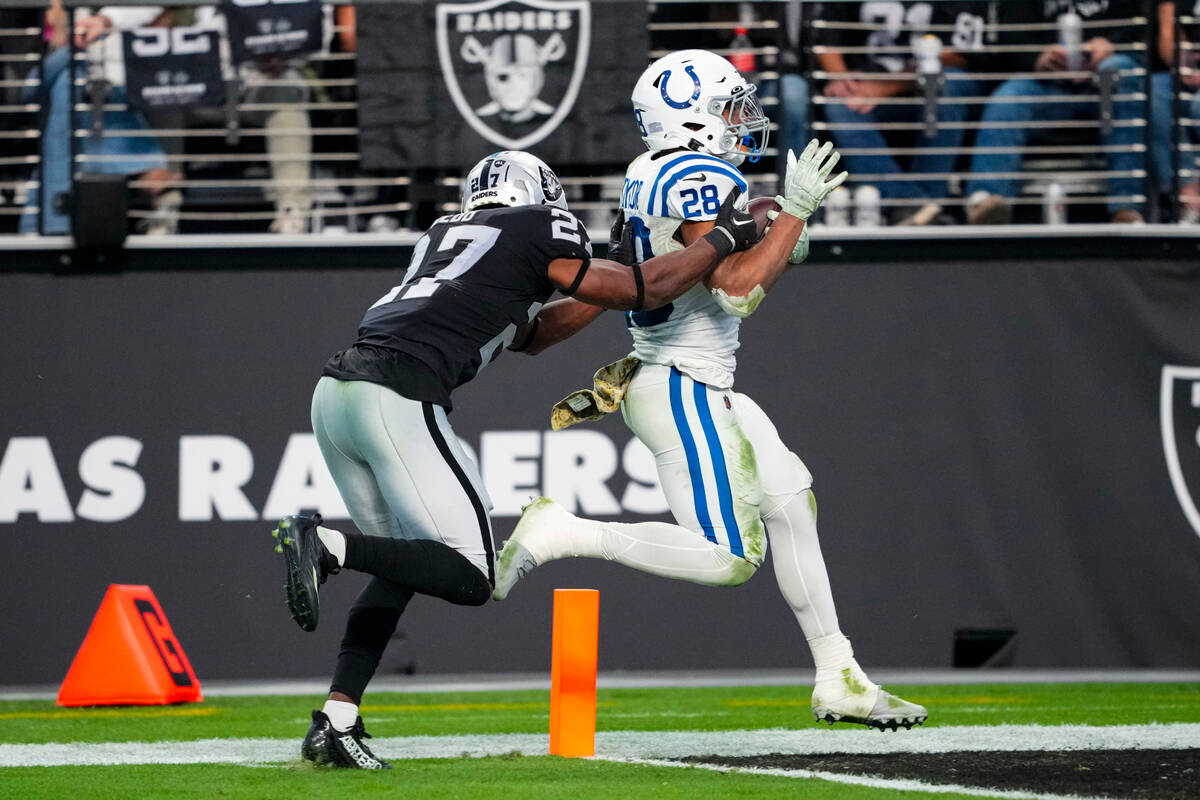 Indianapolis Colts running back Jonathan Taylor (28) runs in for a touchdown in front of Las Ve ...