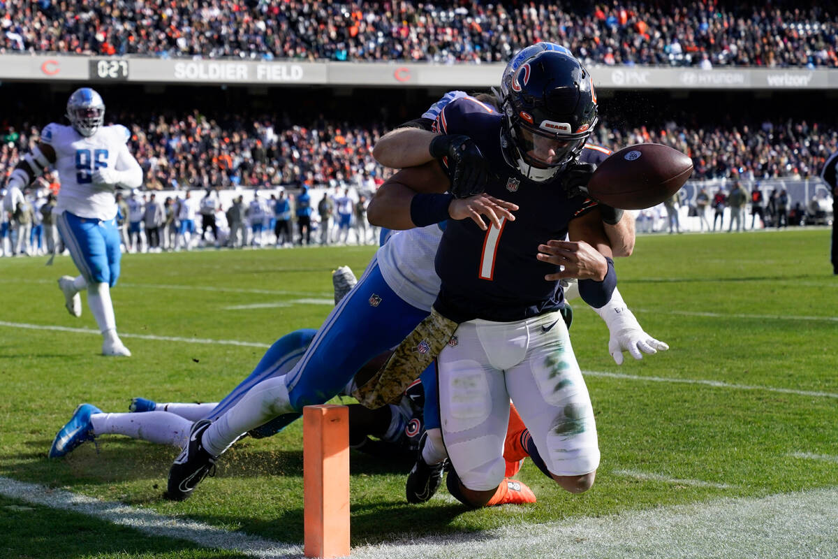 Detroit Lions linebacker Alex Anzalone (34) tackles Chicago Bears quarterback Justin Fields (1) ...