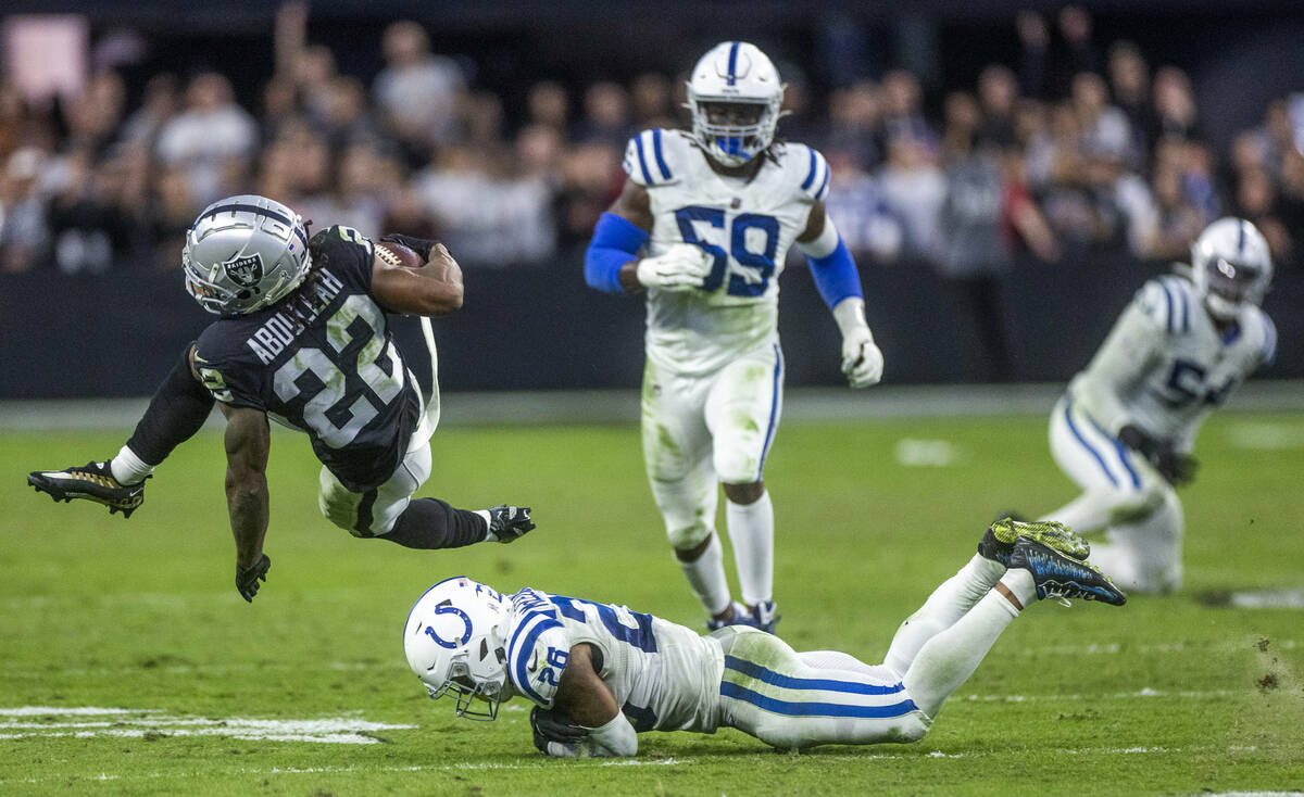 Raiders running back Ameer Abdullah (22) is upended after a catch by Indianapolis Colts safety ...