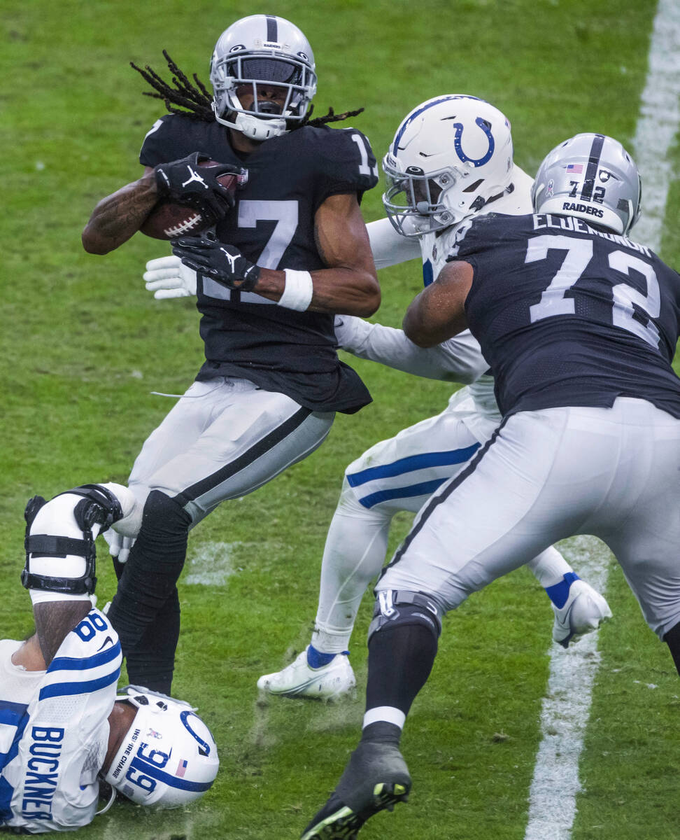 Raiders wide receiver Davante Adams (17) battles for more yards over the Indianapolis Colts def ...